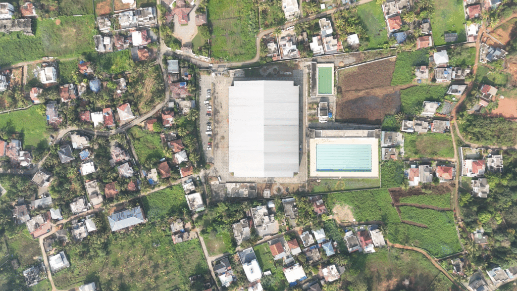 A 90 degree drone shot of Omkaranathan Indoor Stadium Kalppetta